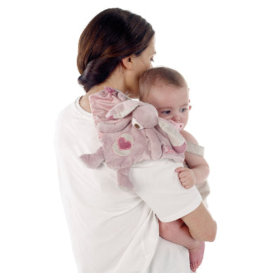 Woman holding a baby wrapped in a pink blanket with a heart design on a white background