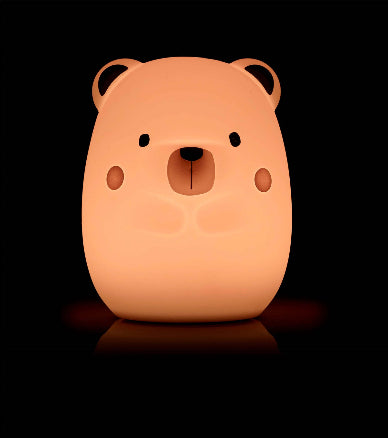 Bear-shaped night light on a black background