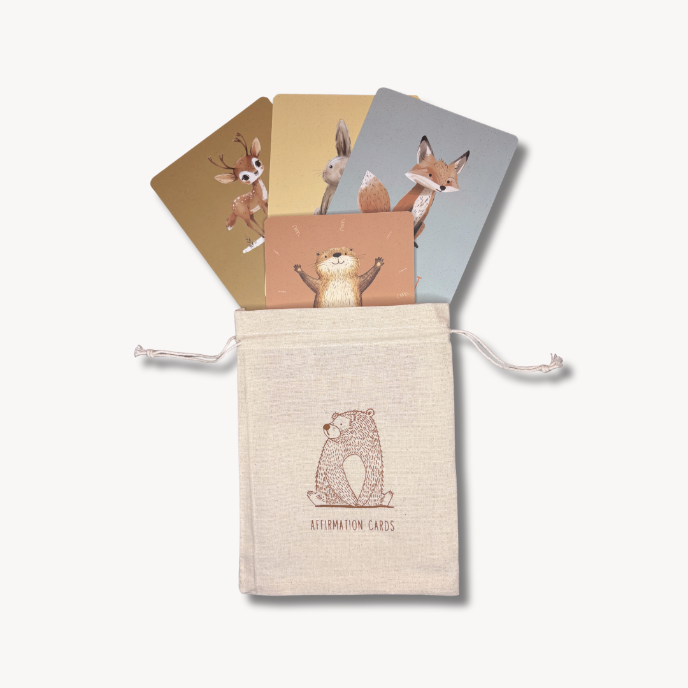 Set of animal-themed cards in a drawstring pouch on a white background