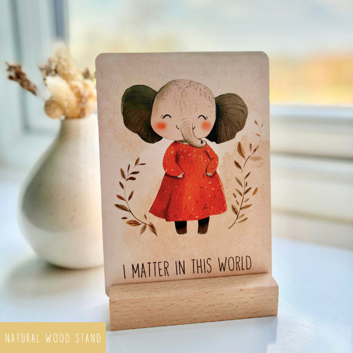 Decorative sign with an elephant illustration and text on a wooden stand.