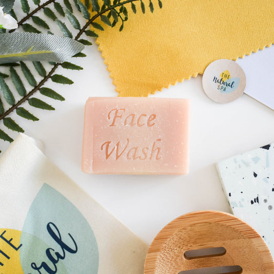 Bar of face wash with natural elements on a white background