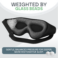 Black sleep mask with glass beads on a light gray background