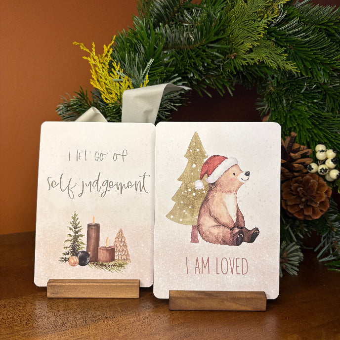 Two motivational cards with illustrations and text on stands, surrounded by festive decorations.