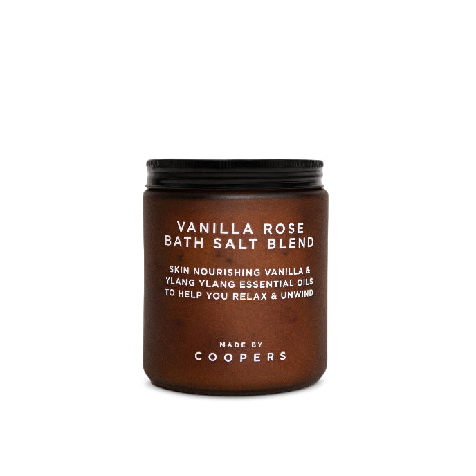 Brown jar of vanilla rose bath salt blend with black lid on a white background