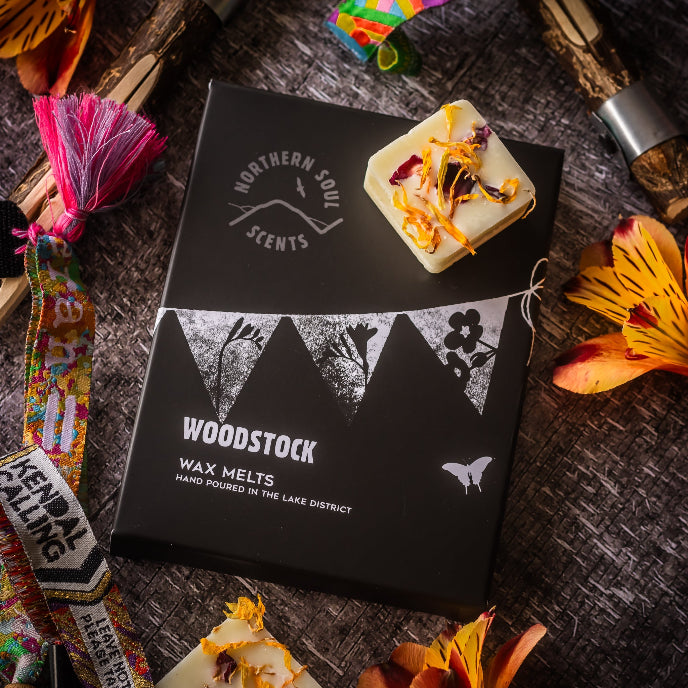 Woodstock wax melts packaging with decorative elements on a rustic surface