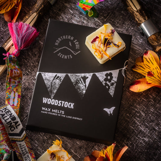 Woodstock wax melts packaging with decorative elements on a rustic surface