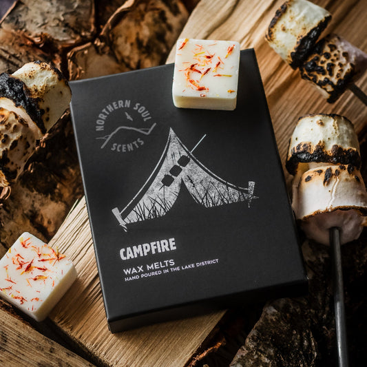 Box of 'Campfire' wax melts from Northern Soul Scents on a wooden surface with roasted marshmallows.