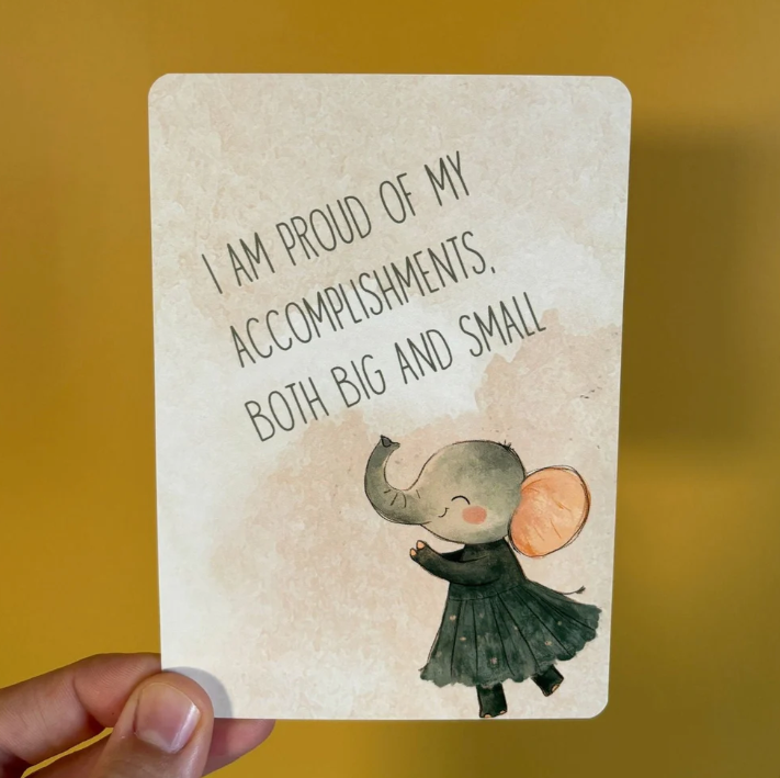 Card with an elephant illustration and motivational quote on a yellow background
