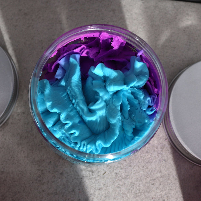 Container with blue and purple slime on a gray surface