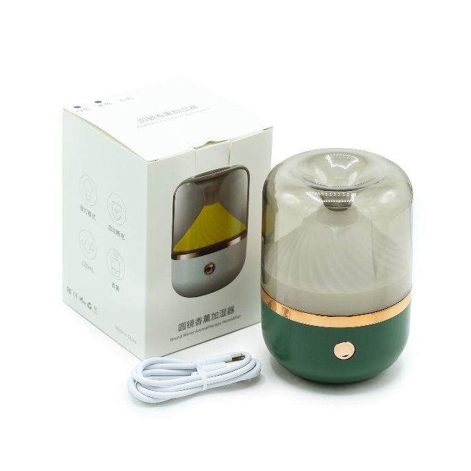 Green diffuser with packaging and cable on a white background