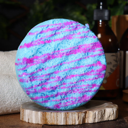 Blue and pink sponge with soap on a wooden stand with blurred background
