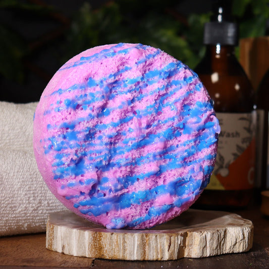 Pink and blue bath bomb on a wooden stand with a blurred background