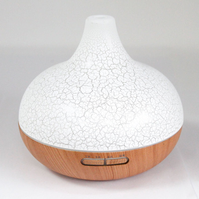 White cracked texture diffuser with wooden base on a light gray background