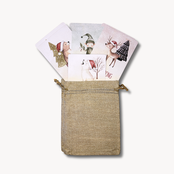 Set of Christmas-themed cards in a jute pouch on a white background