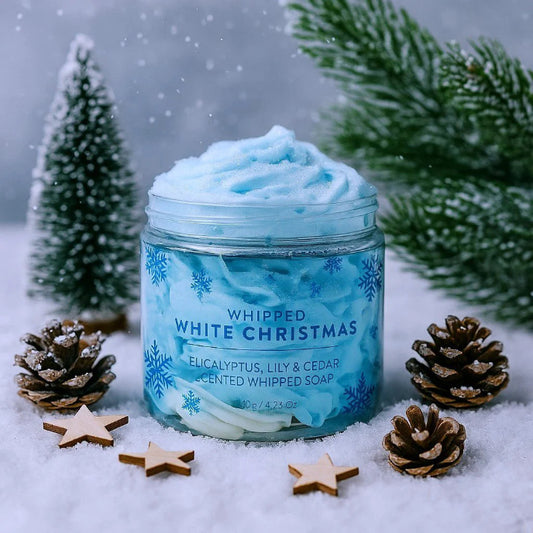 Jar of 'Whipped White Christmas' soap with festive decorations on a snowy background
